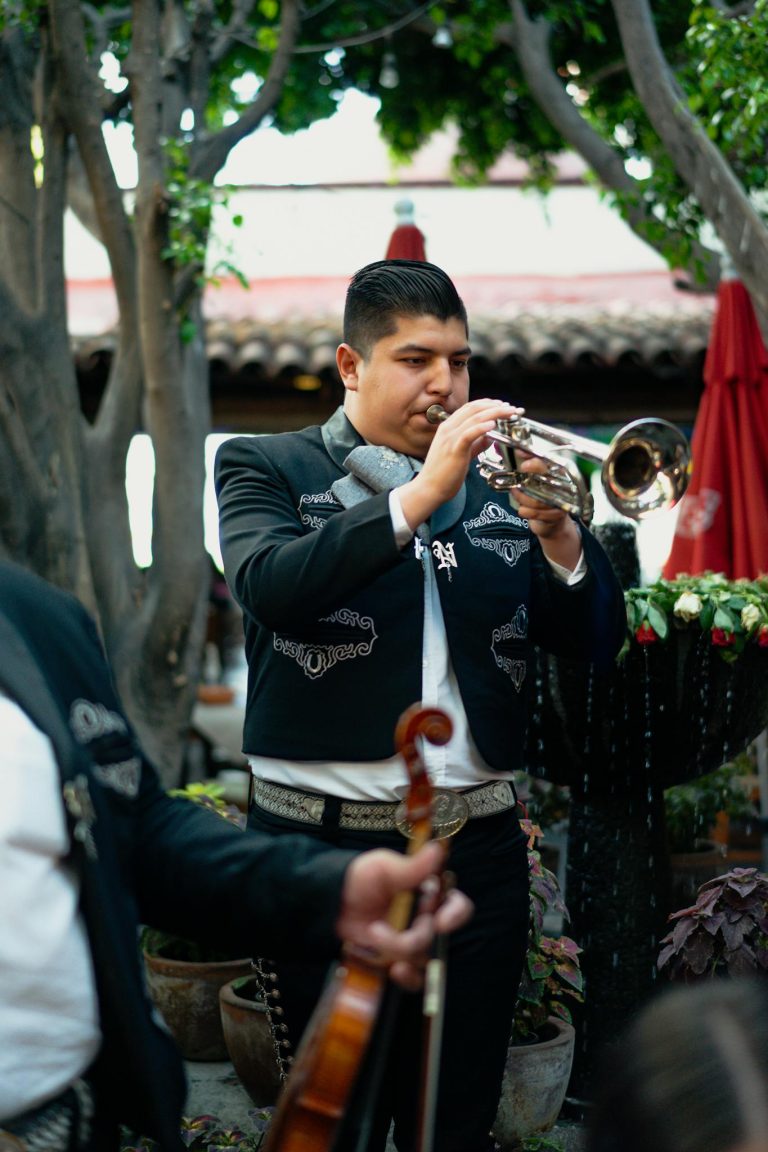 Vibrant outdoor mariachi band performance with traditional attire and musical instruments.