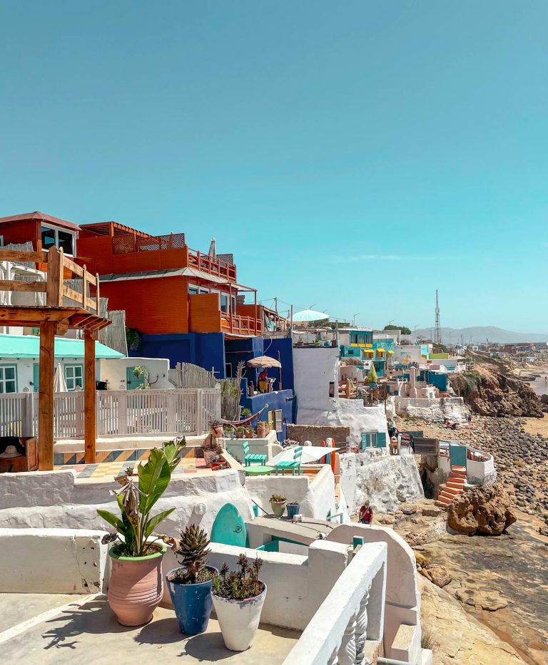 Vibrant seaside homes in Imsouane, Morocco, showcasing a unique architectural charm by the beach.
